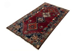 Corner detail of 2000s Shiraz rug showing border pattern and Wool pile