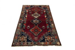 Surface texture of 2000s Shiraz rug with natural Wool and intricate pattern