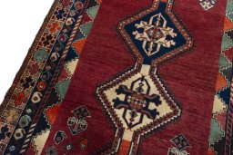 Backside of handmade 2000s Shiraz rug showing knot structure and weave density