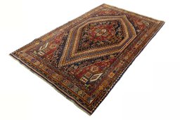 Corner detail of 2000s Shiraz rug showing border pattern and Wool pile