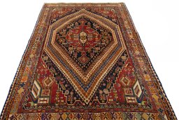 Surface texture of 2000s Shiraz rug with natural Wool and intricate pattern