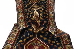 Corner detail of 2000s Shiraz rug showing border pattern and Wool pile
