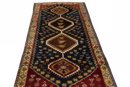 Surface texture of 2000s Shiraz rug with natural Wool and intricate pattern