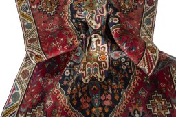 Corner detail of 2000s Shiraz rug showing border pattern and Wool pile