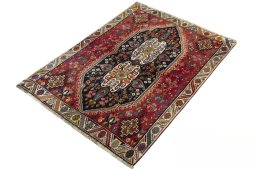 Corner detail of 2000s Shiraz rug showing border pattern and Wool pile