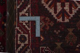 Backside of handmade 2000s Shiraz rug showing knot structure and weave density