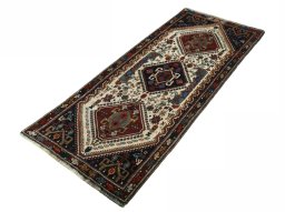 Corner detail of 2000s Shiraz rug showing border pattern and Wool pile