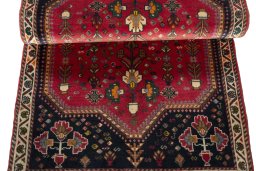 Corner detail of 2000s Shiraz rug showing border pattern and Wool pile