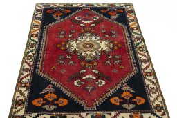 Surface texture of 2000s Shiraz rug with natural Wool and intricate pattern