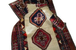 Corner detail of 2000s Shiraz rug showing border pattern and Wool pile