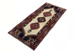 Corner detail of 2000s Shiraz rug showing border pattern and Wool pile