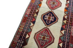 Backside of handmade 2000s Shiraz rug showing knot structure and weave density