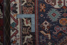 Backside of handmade 2000s Shiraz rug showing knot structure and weave density