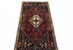 Surface texture of 2000s Shiraz rug with natural Wool and intricate pattern