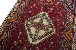 Backside of handmade 2000s Shiraz rug showing knot structure and weave density