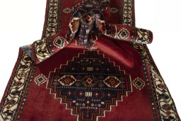 Corner detail of 2000s Shiraz rug showing border pattern and Wool pile