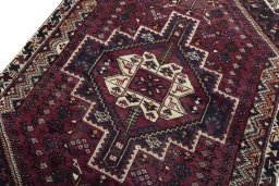 Backside of handmade 2000s Shiraz rug showing knot structure and weave density