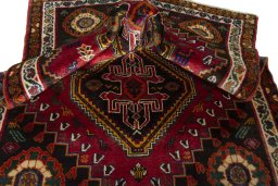 Corner detail of 2000s Shiraz rug showing border pattern and Wool pile