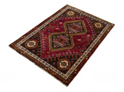 Corner detail of 2000s Shiraz rug showing border pattern and Wool pile
