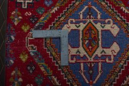 Backside of handmade 2000s Shiraz rug showing knot structure and weave density