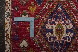Backside of handmade 2000s Shiraz rug showing knot structure and weave density