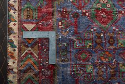 Backside of handmade 2000s Shiraz rug showing knot structure and weave density