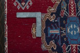 Backside of handmade 2000s Shiraz rug showing knot structure and weave density