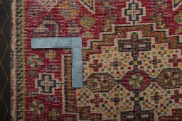 Backside of handmade 2000s Shiraz rug showing knot structure and weave density