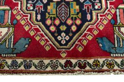 Backside of handmade 2000s Shiraz rug showing knot structure and weave density