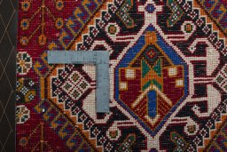 Backside of handmade 2000s Shiraz rug showing knot structure and weave density