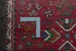 Backside of handmade 2000s Shiraz rug showing knot structure and weave density