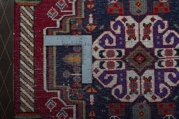 Backside of handmade 2000s Shiraz rug showing knot structure and weave density