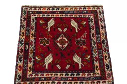 Surface texture of 2000s Shiraz rug with natural Wool and intricate pattern