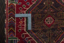 Backside of handmade 2000s Shiraz rug showing knot structure and weave density
