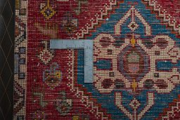 Backside of handmade 2000s Shiraz rug showing knot structure and weave density