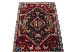 Surface texture of 2000s Shiraz rug with natural Wool and intricate pattern