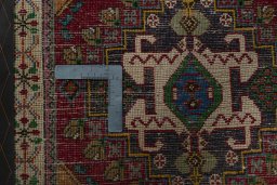 Backside of handmade 2000s Shiraz rug showing knot structure and weave density