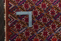 Backside of handmade 2000s Shiraz rug showing knot structure and weave density