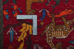 Backside of handmade 2000s Shiraz rug showing knot structure and weave density