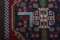 Backside of handmade 2000s Shiraz rug showing knot structure and weave density