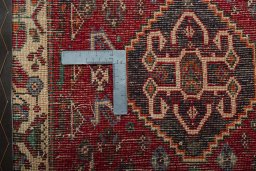 Backside of handmade 2000s Shiraz rug showing knot structure and weave density
