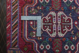 Backside of handmade 2000s Shiraz rug showing knot structure and weave density