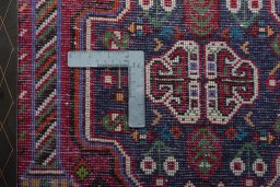 Backside of handmade 2000s Shiraz rug showing knot structure and weave density