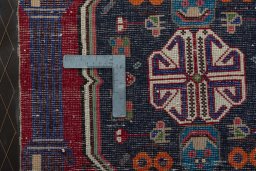 Backside of handmade 2000s Shiraz rug showing knot structure and weave density