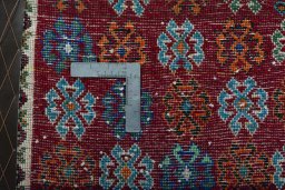 Backside of handmade 2000s Shiraz rug showing knot structure and weave density