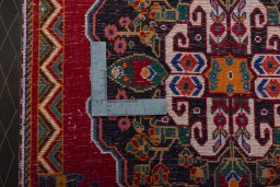 Backside of handmade 2000s Shiraz rug showing knot structure and weave density