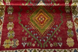 Corner detail of 2000s Shiraz rug showing border pattern and Wool pile