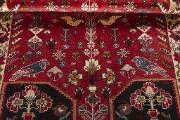 Corner detail of 2000s Shiraz rug showing border pattern and Wool pile