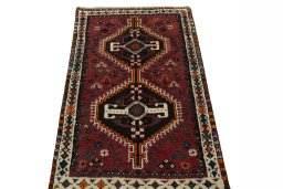 Surface texture of 2000s Shiraz rug with natural Wool and intricate pattern
