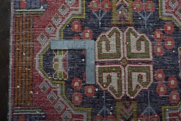 Backside of handmade 2000s Shiraz rug showing knot structure and weave density